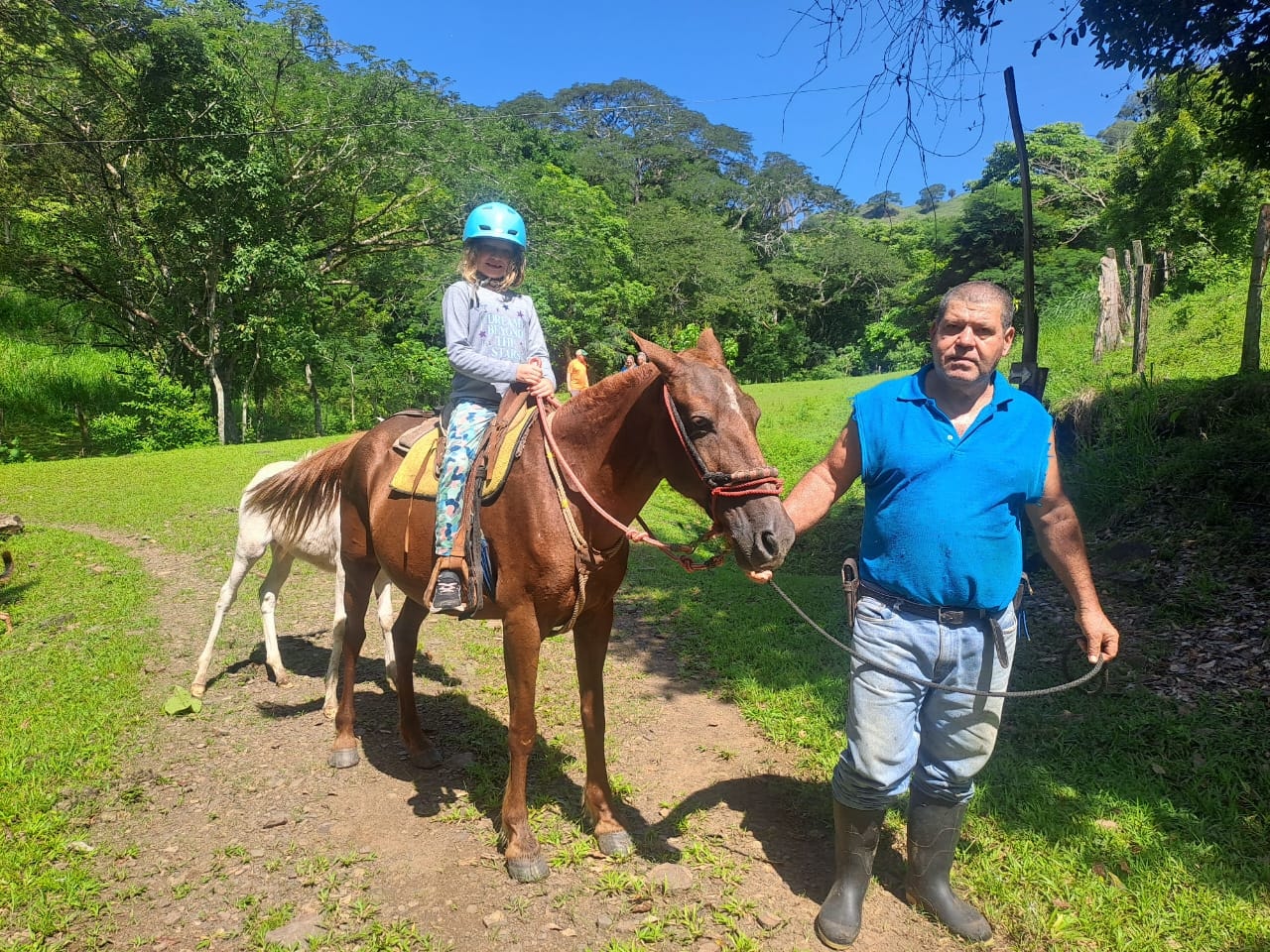 Child on horseback with guide on a nature trail in Costa Rica